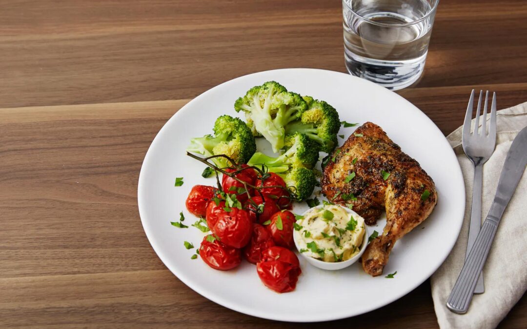 Roasted chicken legs and cherry tomatoes with garlic-butter